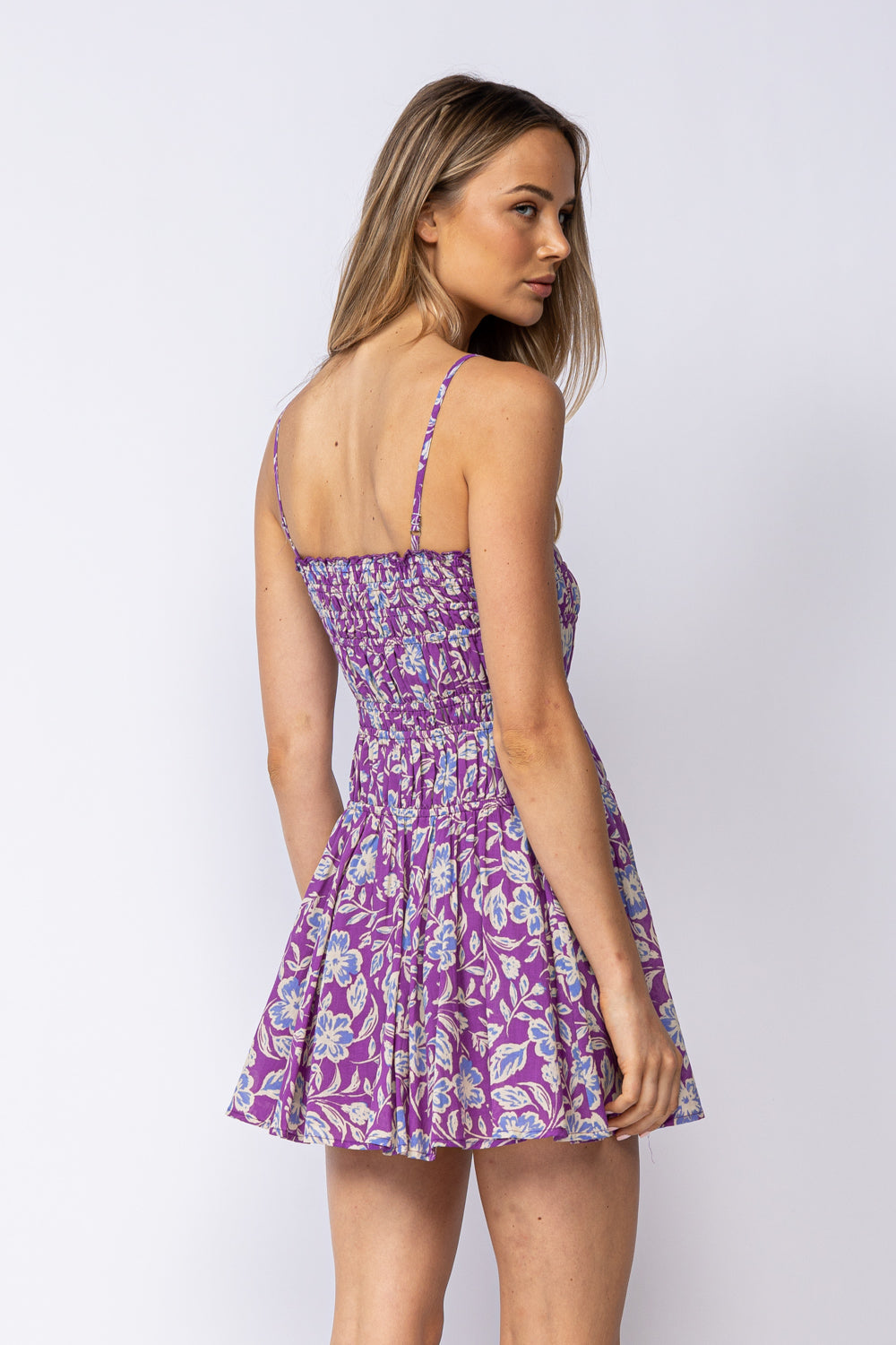 Purple floral dress back view, thin spaghetti straps, gathered waist, above-knee length