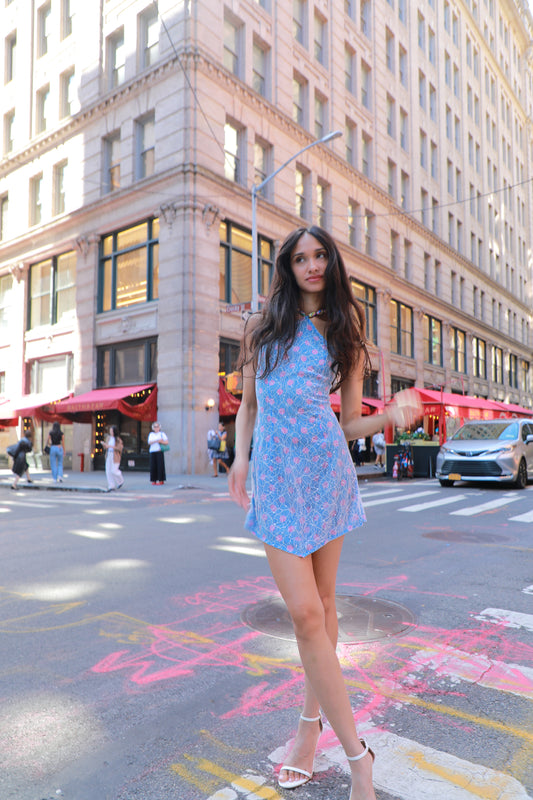 Sleeveless light blue silk dress with pink floral print, short hem