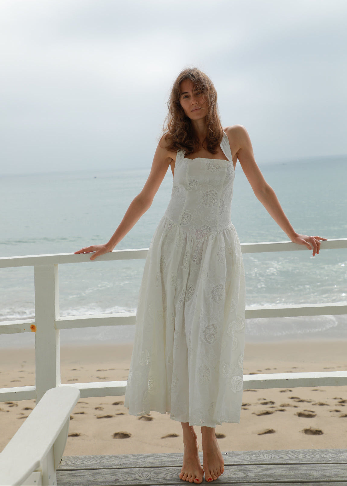White lace halter dress with square neckline, fitted waist, and full midi skirt
