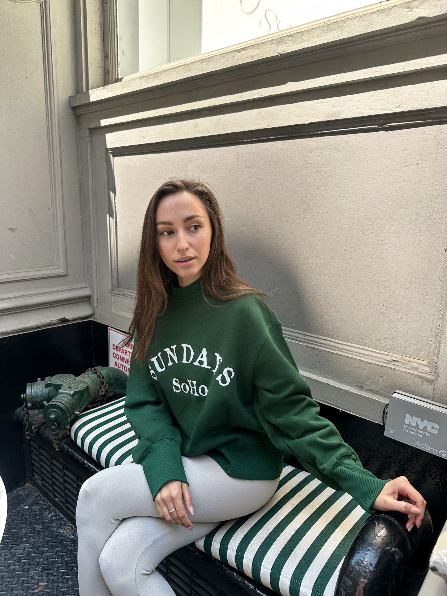 Dark green crewneck sweatshirt with white “Sunday SoHo” print and long sleeves