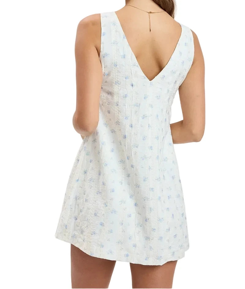 Backless sleeveless white dress with light blue speckled print and V-back