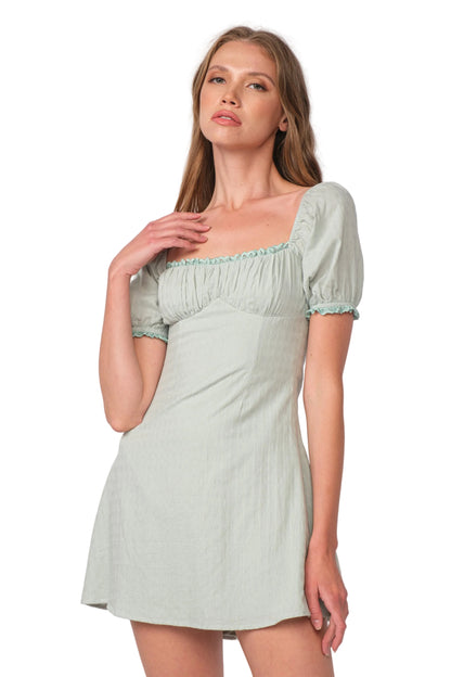 Rachel dress in sage green with square neckline and puff sleeves, short A-line mini.