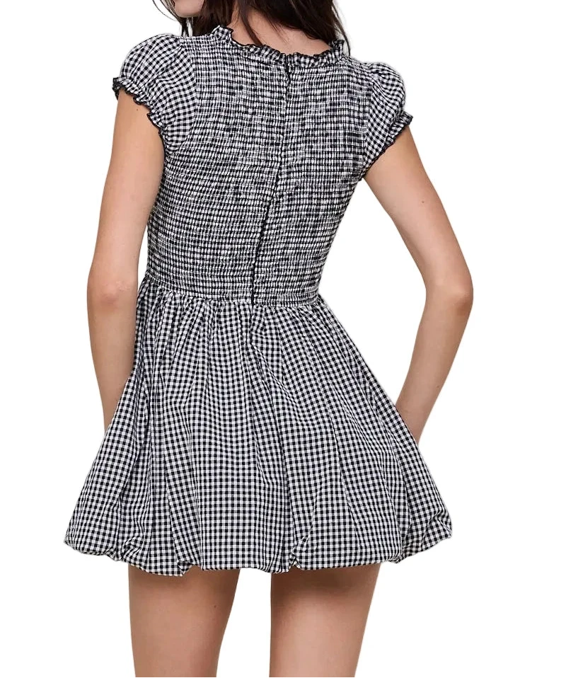 Gingham mini dress with smocked bodice, bow tie front, and flared skirt