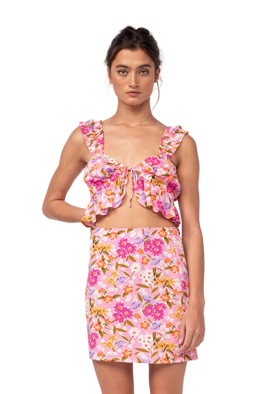 Floral two-piece set with ruffled pink crop top and matching mini skirt