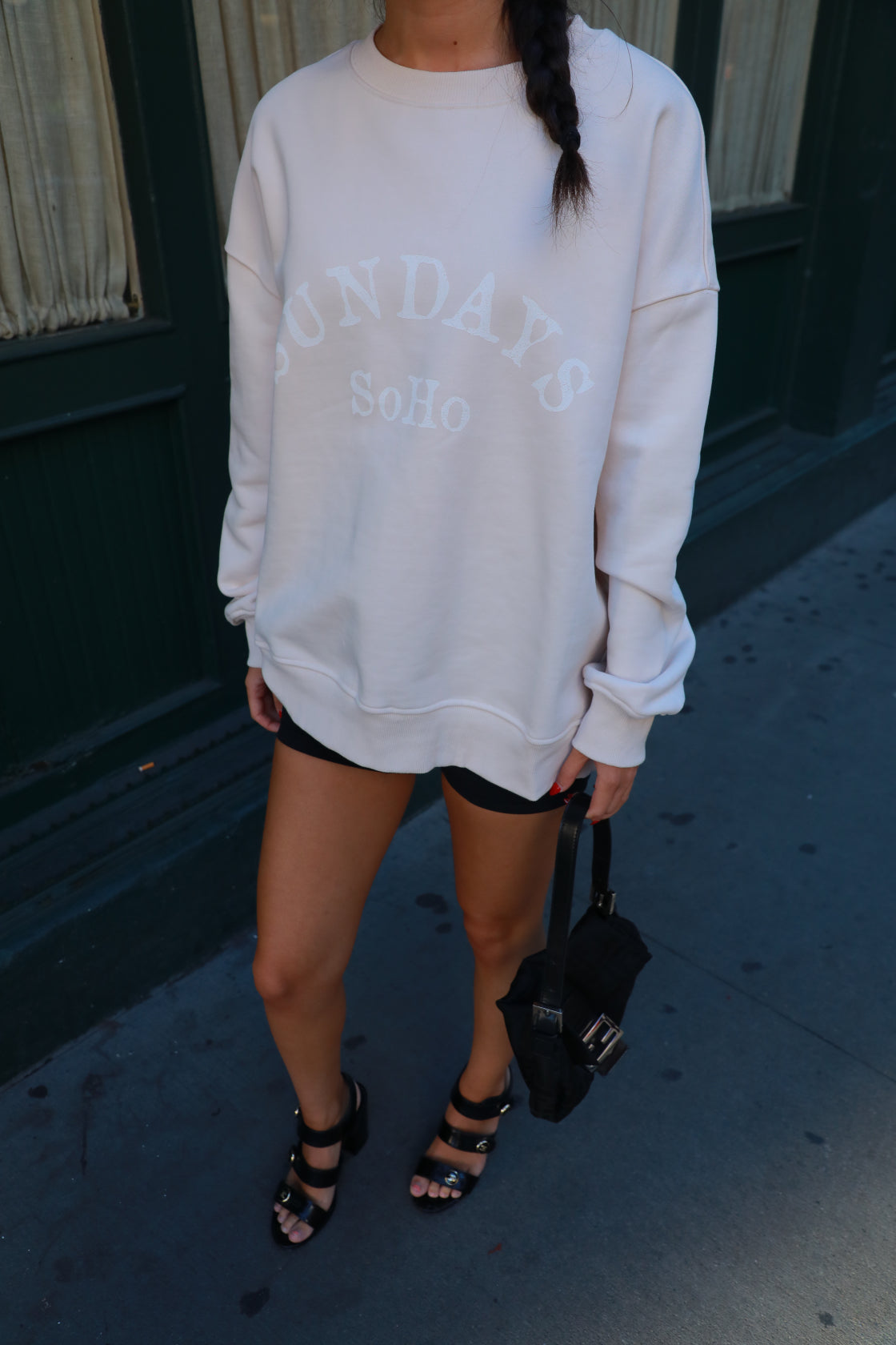 White crewneck sweatshirt with long sleeves and front embroidered-style lettering