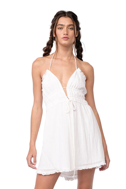 White halter mini dress with lace-up front and ruffled hem