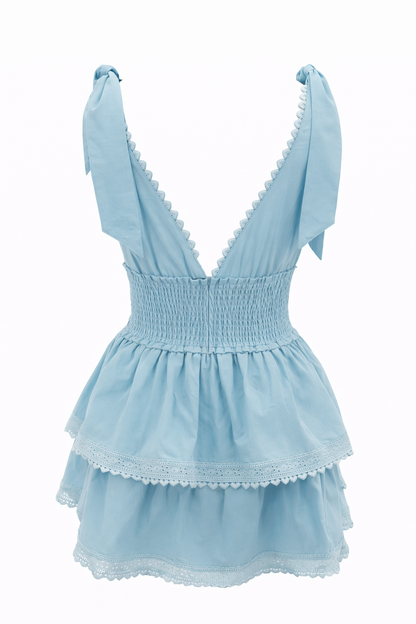 Light blue mini dress with V-neck, smocked waist, and layered lace-edged ruffles