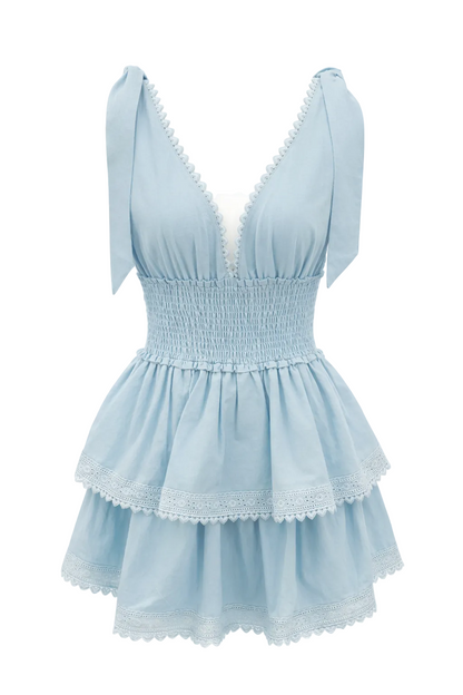 Light blue dress with V-neck, puffed shoulders, smocked waist, lace-trim tiers