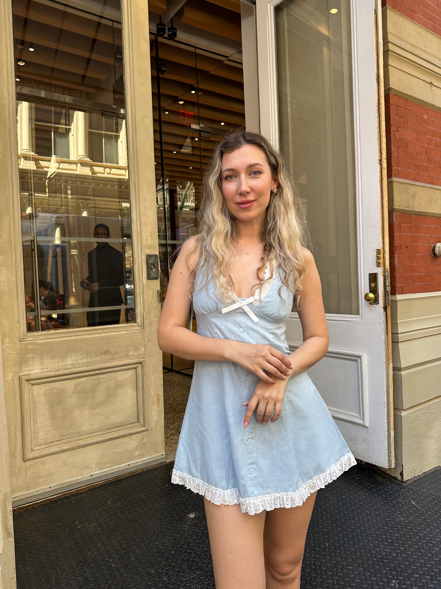 Light blue sleeveless skater dress with lace neckline and front button placket