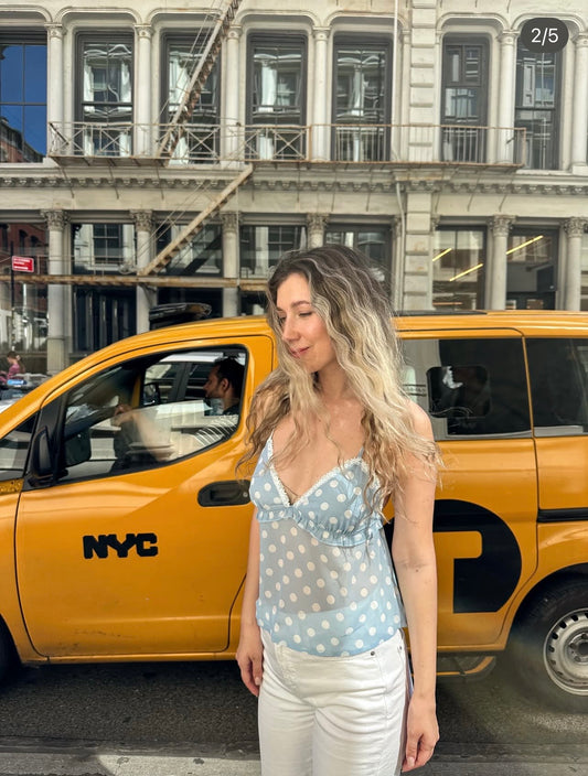 Light blue polka-dot camisole top with V-neck and thin spaghetti straps
