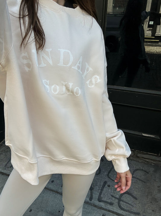 Cream crewneck sweatshirt with large faded graphic print on front