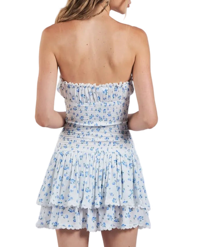 Back view of strapless blue floral smocked tiered dress with ruffle hem