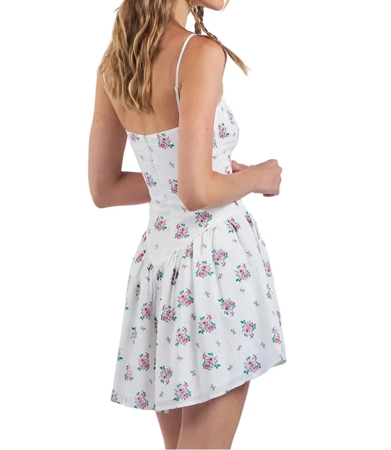 White floral sundress back view with spaghetti straps and gathered waist